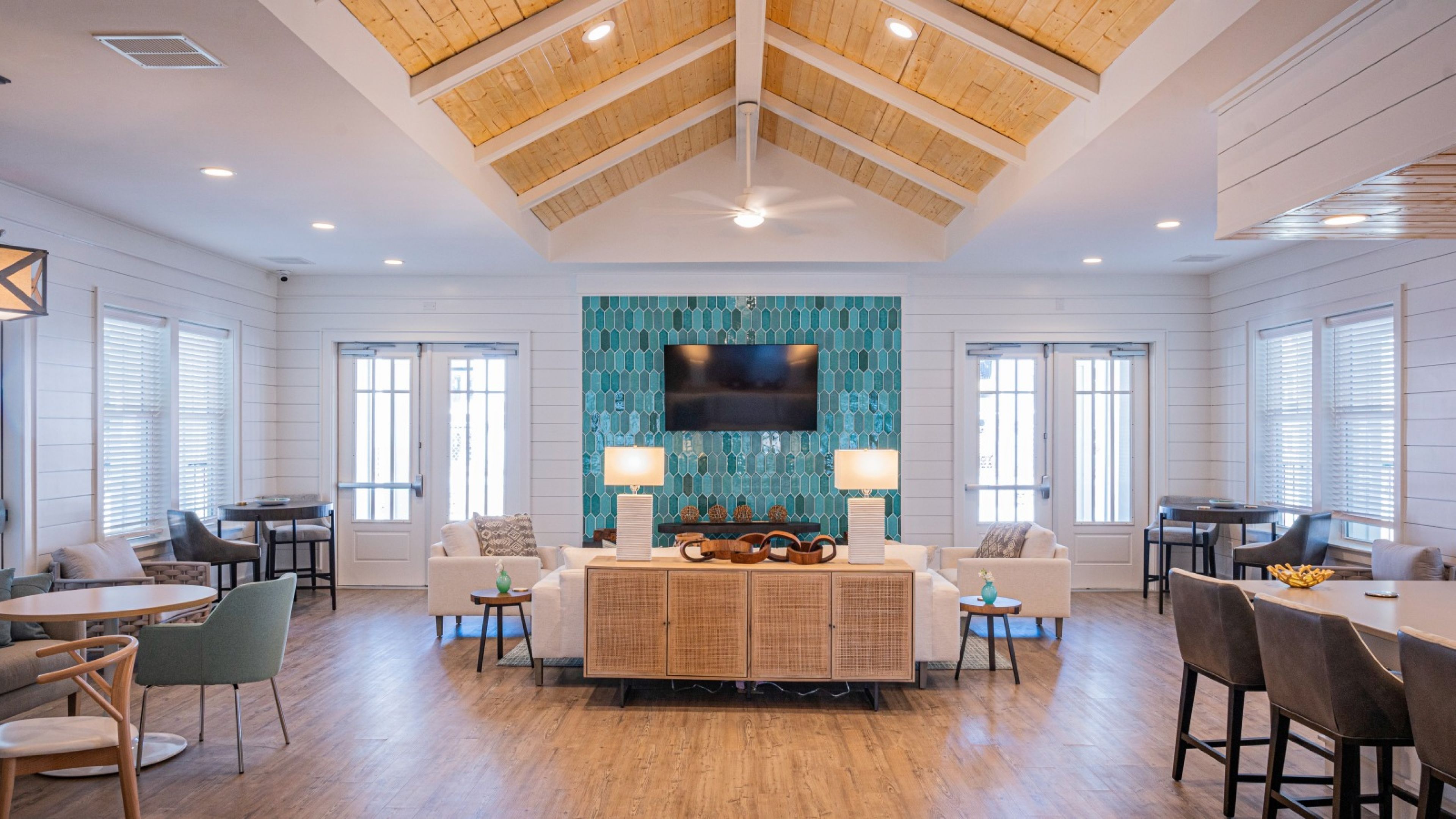 Hawthorne at Pine Forest lobby at Hawthorne at Pine Forest with vault ceiling, seating area, and large TV