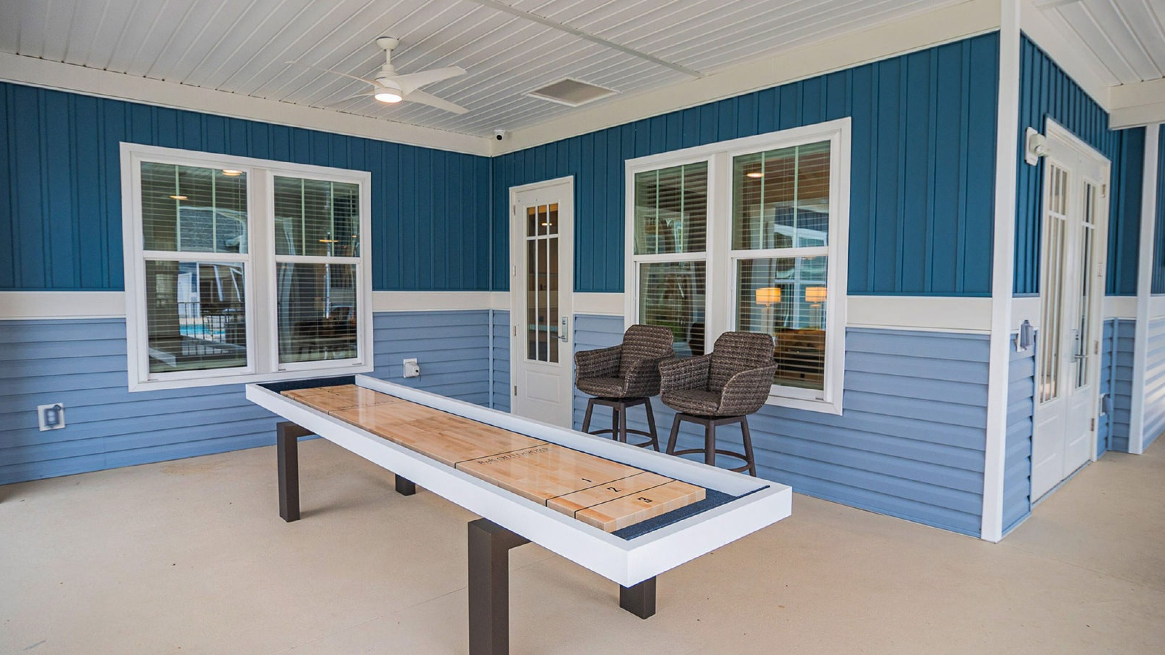 Hawthorne at Pine Forest shuffleboard game located on outdoor porch at Hawthorne Pine Forest